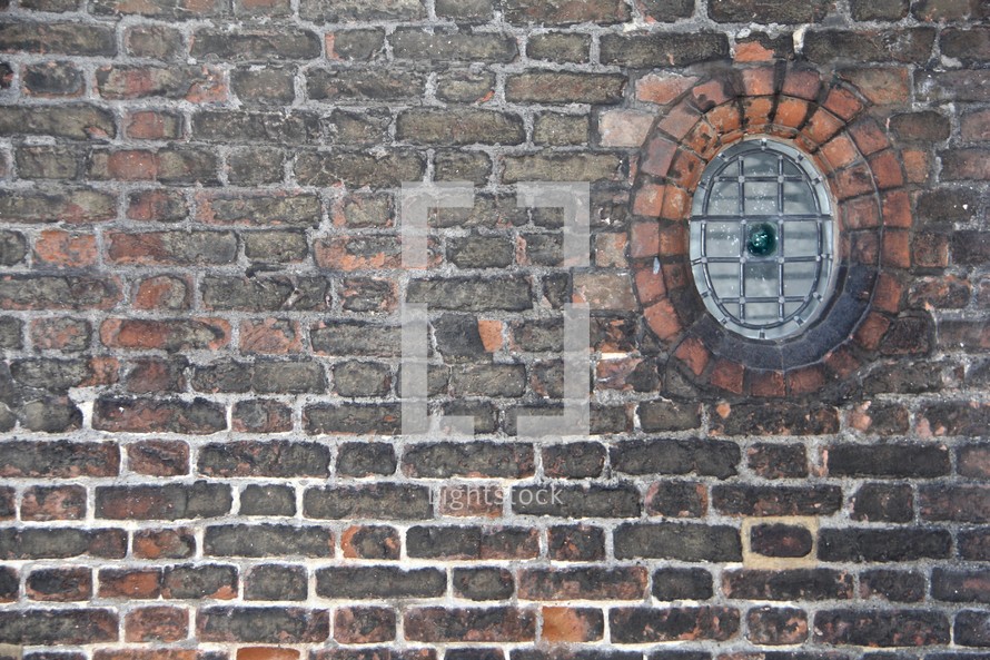 circular window in a brick wall 