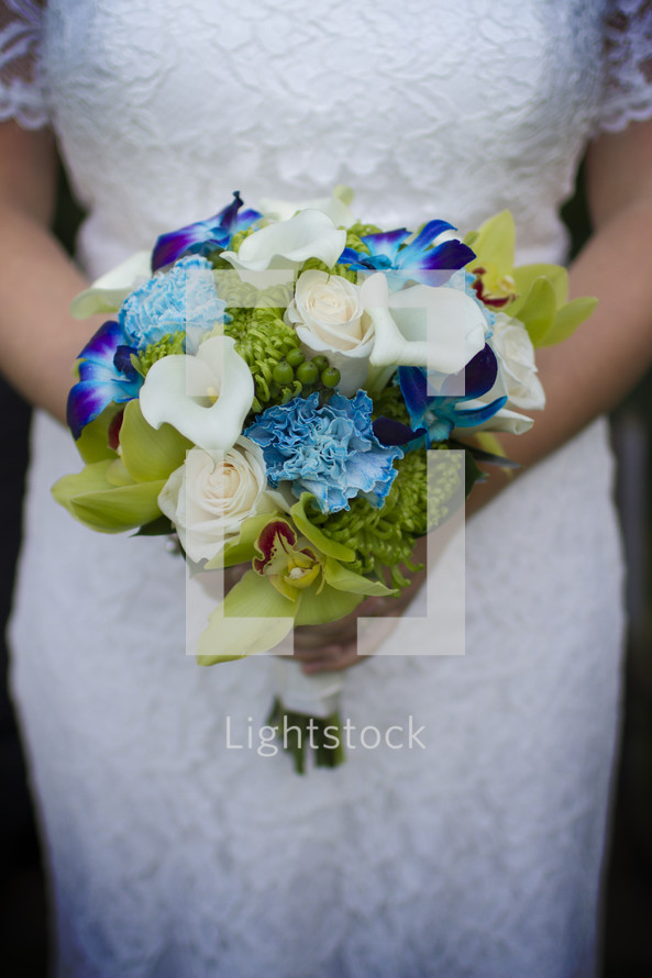 A bride holding a colorful bouquet.