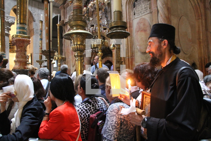 worshipers, prayers, and candles in a church in Jerusalem 