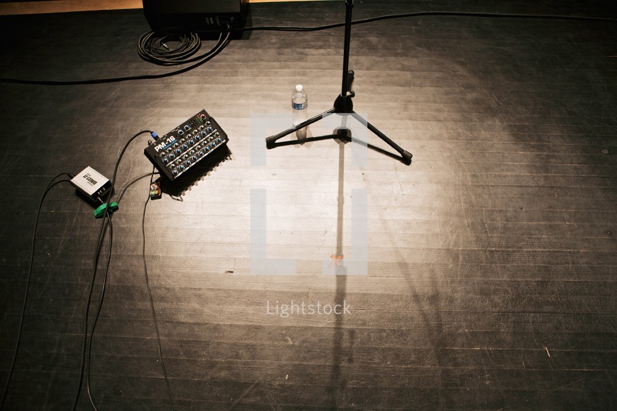 sound board and microphone stand on a stage