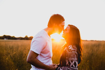 couple in a field at sunset 