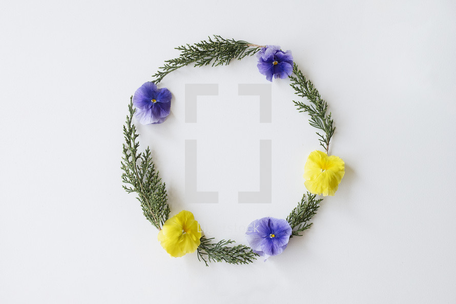 greenery and pansies frame on white 