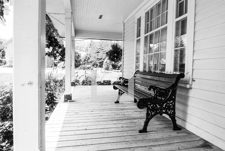 Park bench on the front porch of a house.