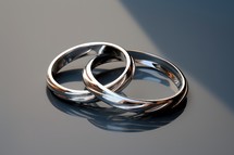 Sacrament: Matrimony. Wedding rings on a reflective surface