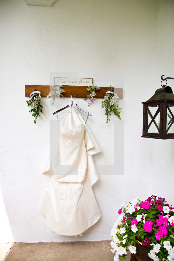 wedding dress hanging on a hook 