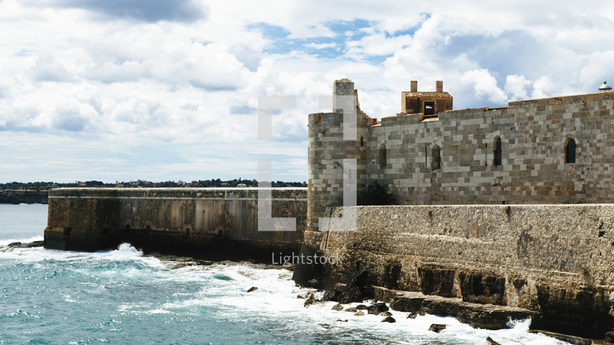 Castle of Meniace in Syracusa Ortigia Island on the sea waves