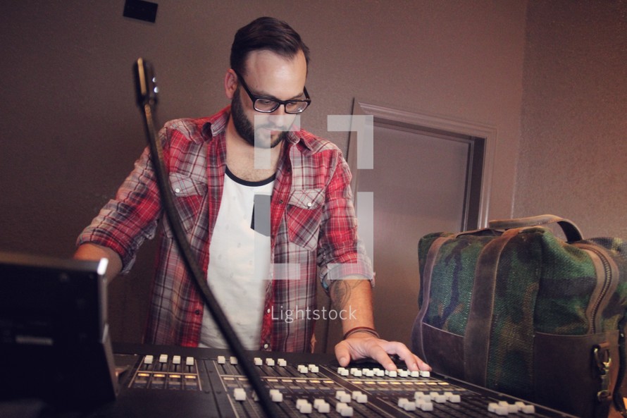 a man in a studio on a sound board 