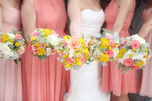 bride and bridesmaids holding bouquets 