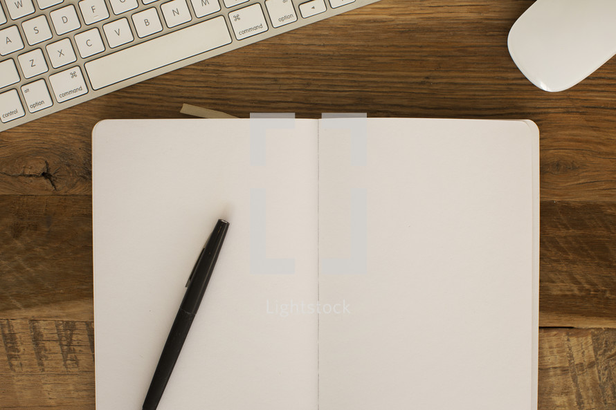 Blank open journal on a desktop.