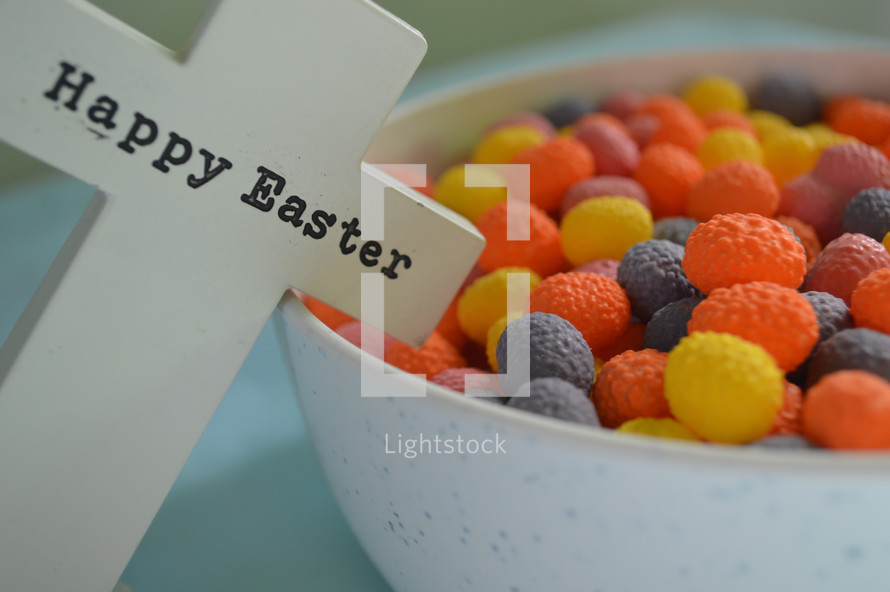 bowl of candy and cross with words Happy Easter 