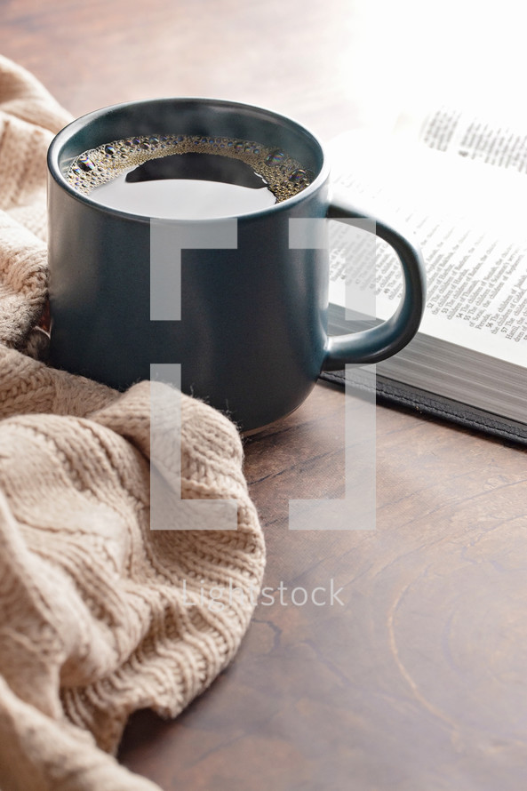 coffee cup and sweater with open Bible 
