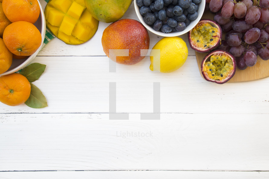 fruit border on a white wood background 