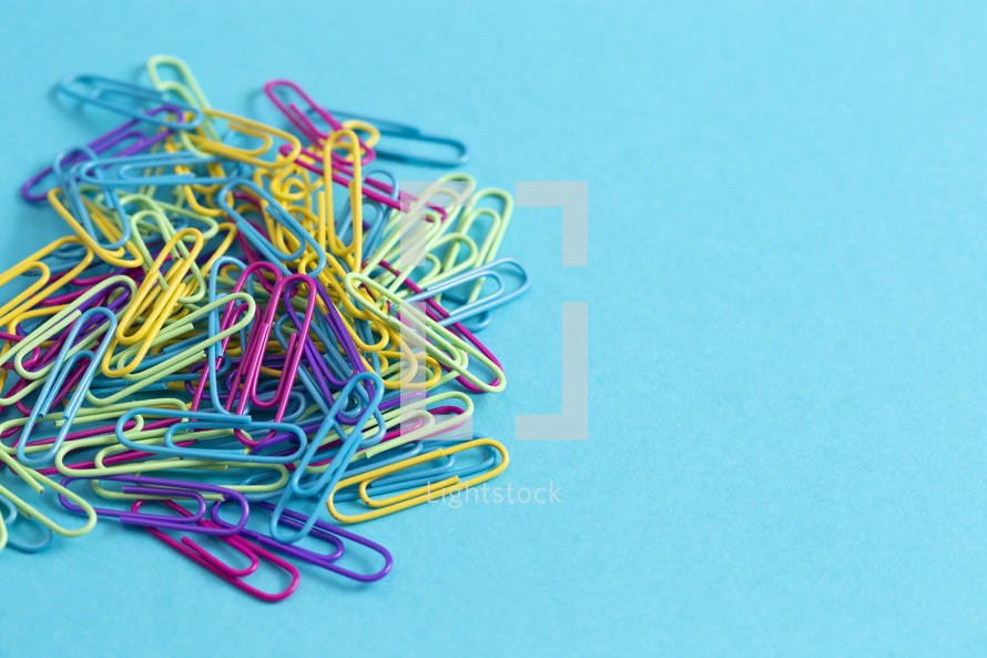 pile of rainbow colored paperclips 
