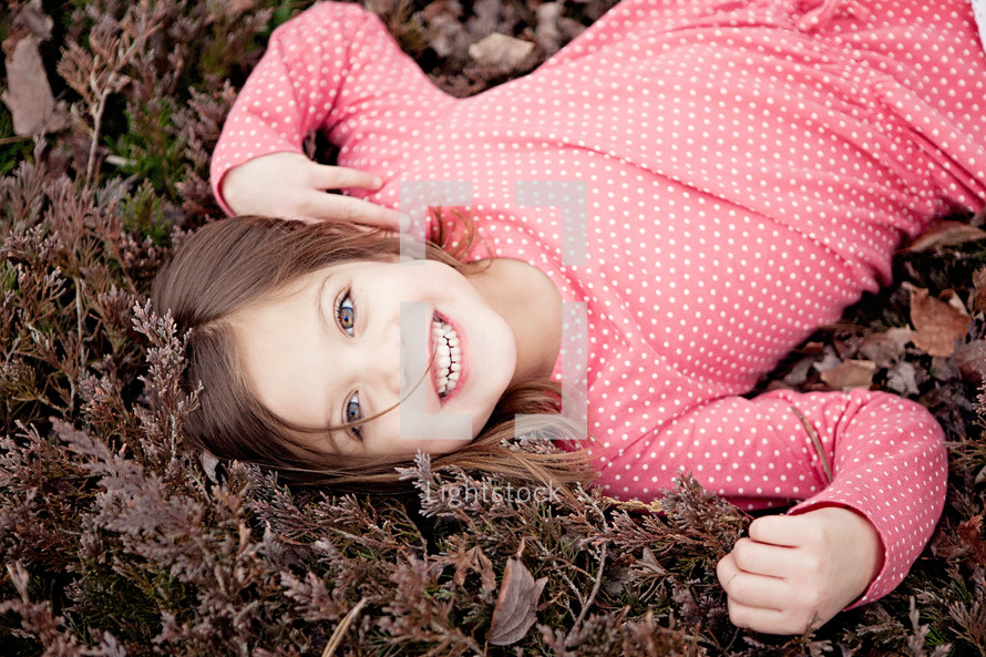 child lying on the ground 