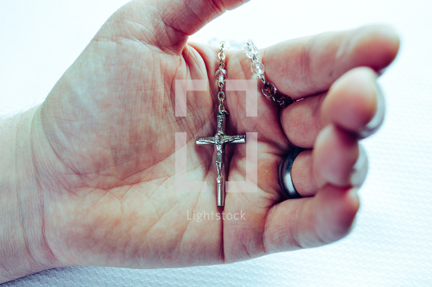 hand holding a rosary 