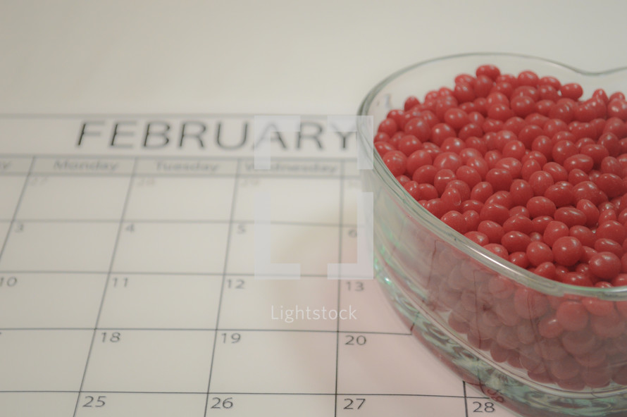February calendar and bowl of red hot candies 