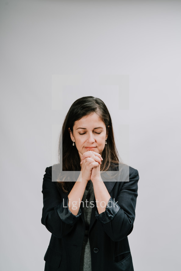 a woman standing praying 