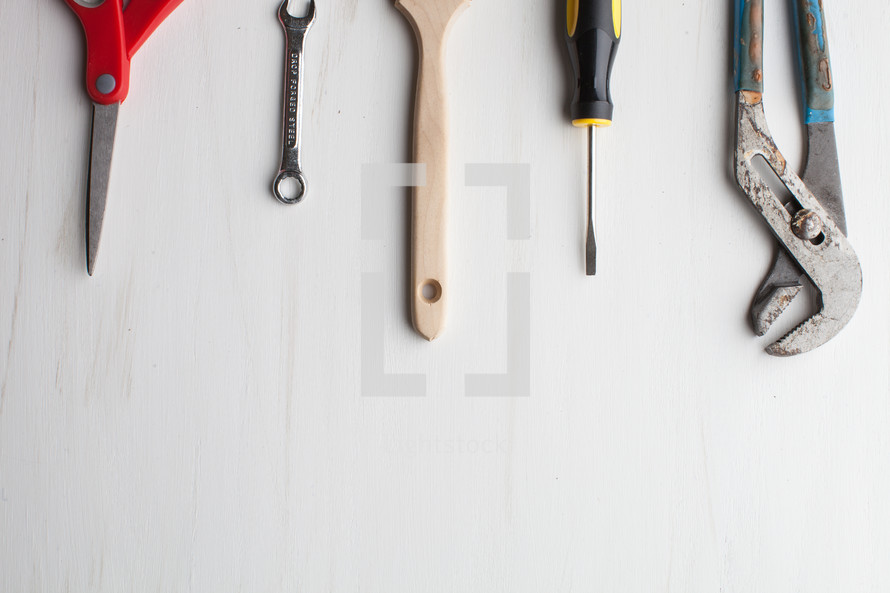 Tools lined up at the top of a white background.