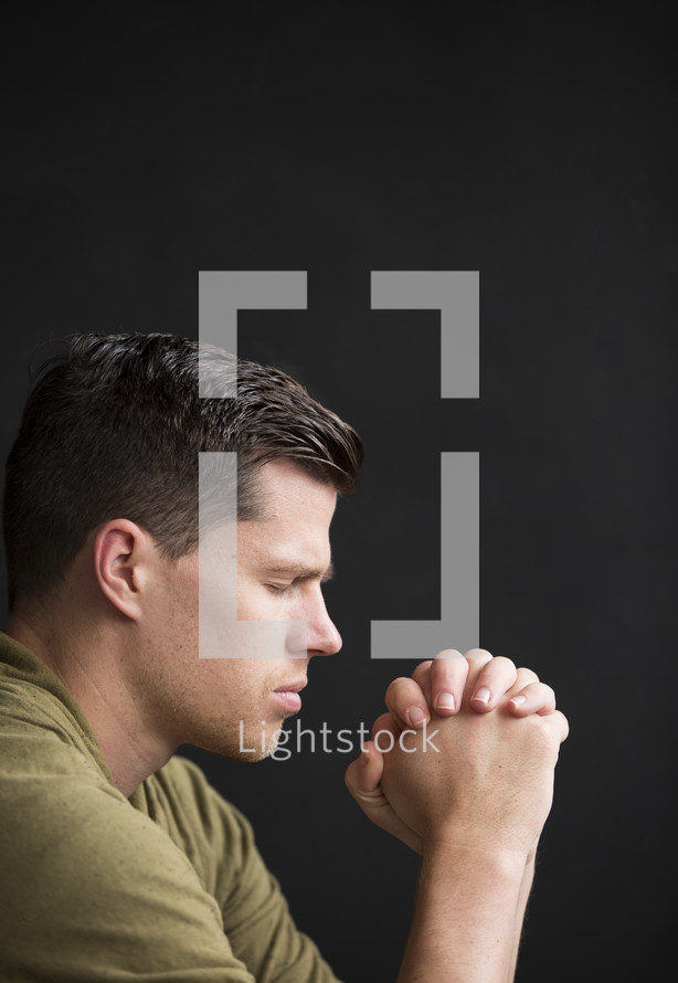 a side profile of a man in prayer 