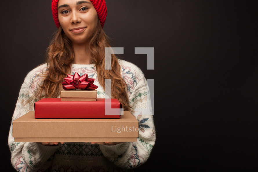 a woman holding gift boxes 