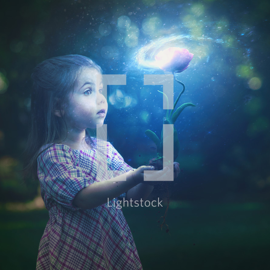 A little girl holds a glowing flower with a bright galaxy