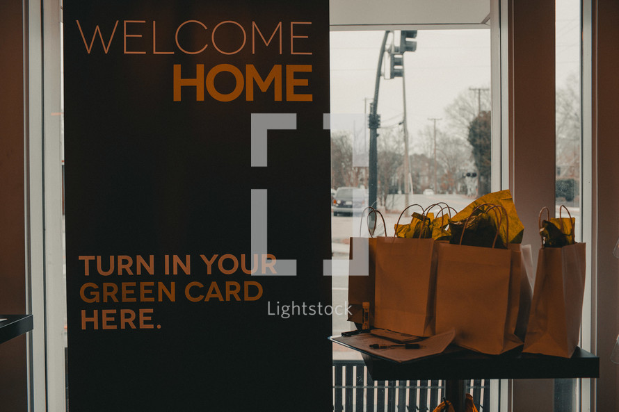 Welcome Home, Turn in Your Green Card Here sign 