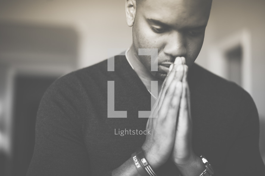 African-American man with praying hands 