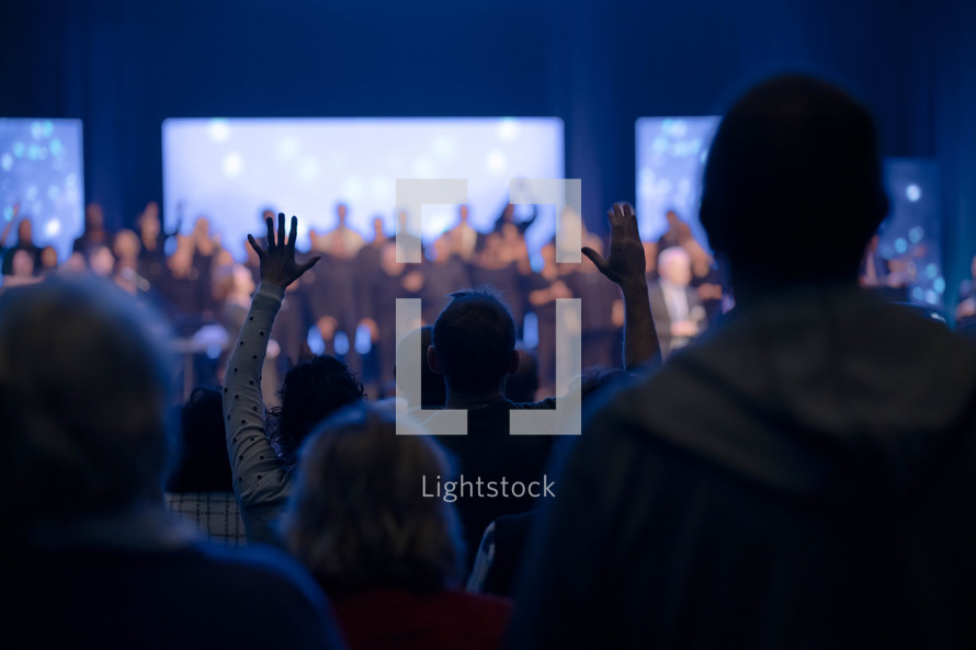 raised hands in the audience at a worship service 