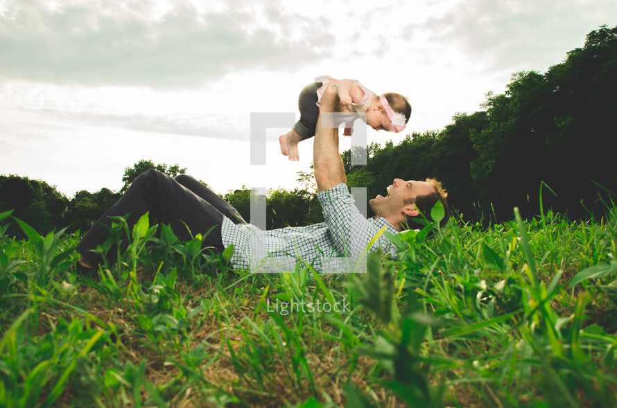 Father holding his daughter in the air