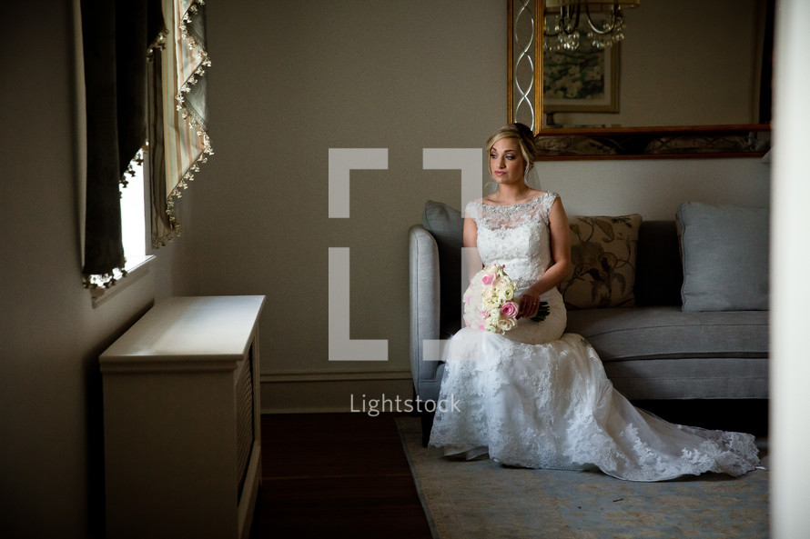 bride sitting on a couch waiting 