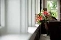 A wedding bouquet in a sunny window.