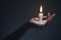 melted candle and wax in a woman's hand 