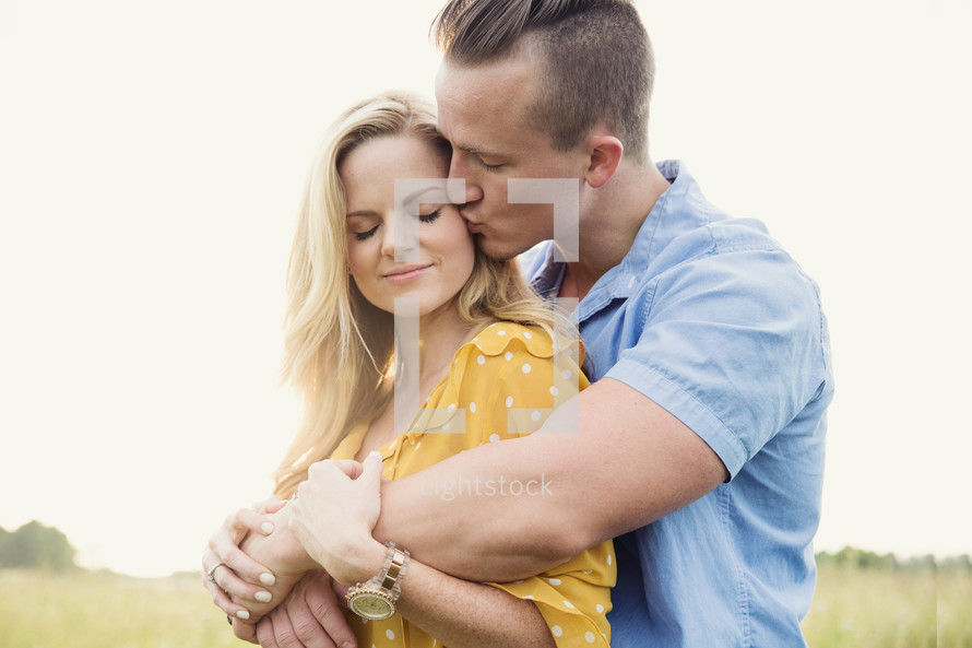 a man kissing a woman on the cheek 