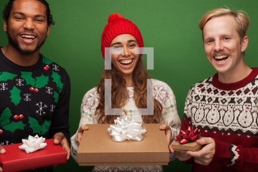 people holding gifts at a holiday party 
