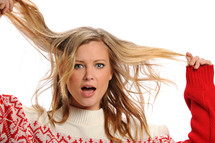 woman pulling her hair in a winter sweater 