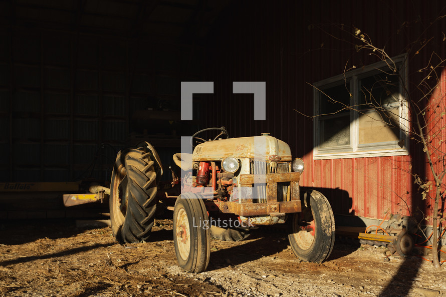 Red, vintage tractor in a barn