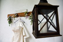 wedding dress hanging on a hook and lantern