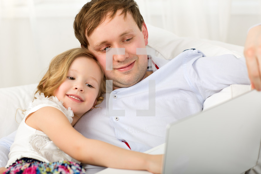 Happy dad and daughter with laptop