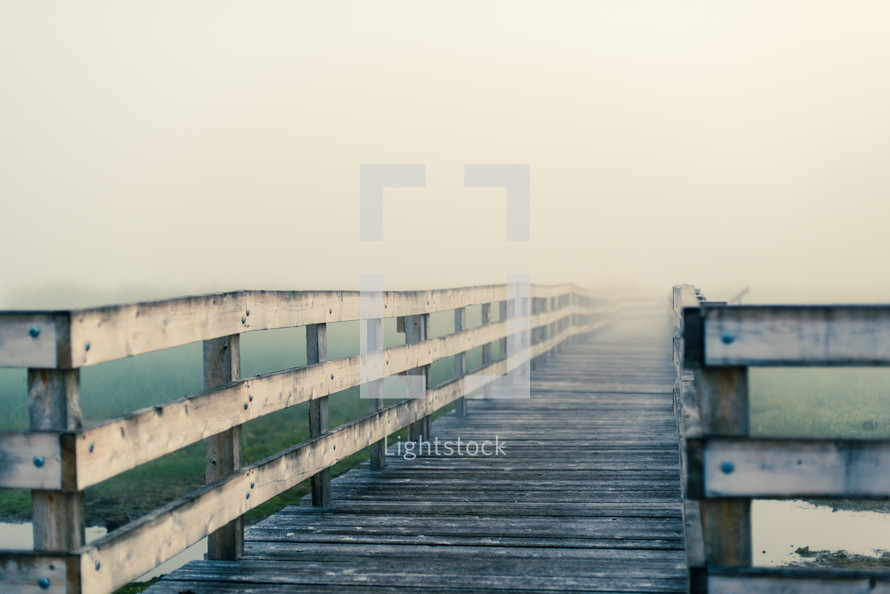 a boardwalk over a marsh 