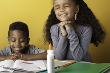 children coloring and praying 
