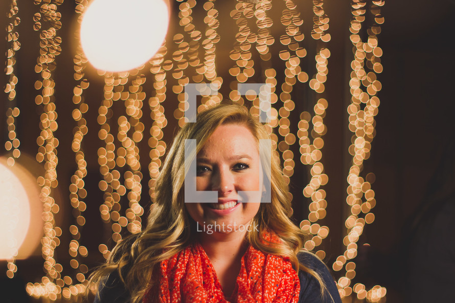 Smiling woman with sparkling lights.