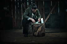 a man in a barn reading a Bible 