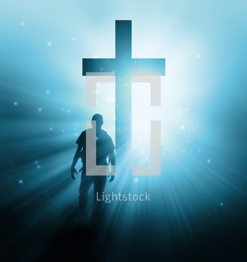 man with a back pack walking towards a glowing cross