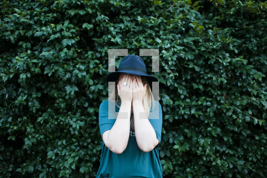 a woman covering her eyes 