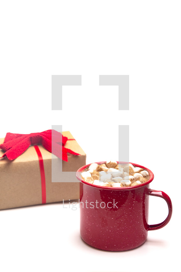 gift and mug of hot cocoa 