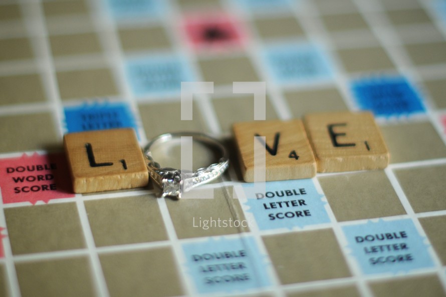 Love out of scrabble pieces and an engagement ring 