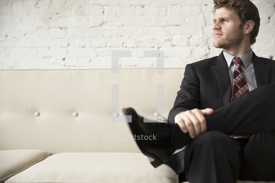 businessman sitting on a couch 