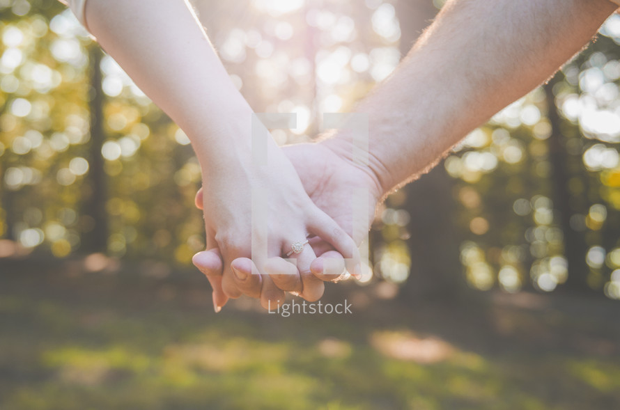couple holding hands 