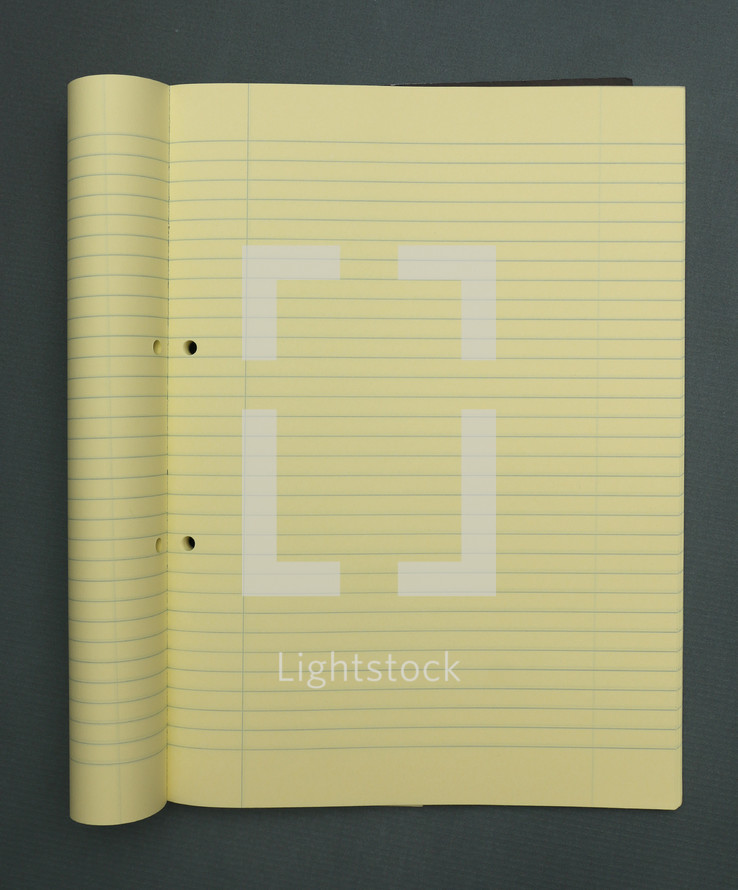 yellow lined paper in a notebook 