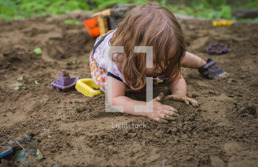 a kid playing in dirt 